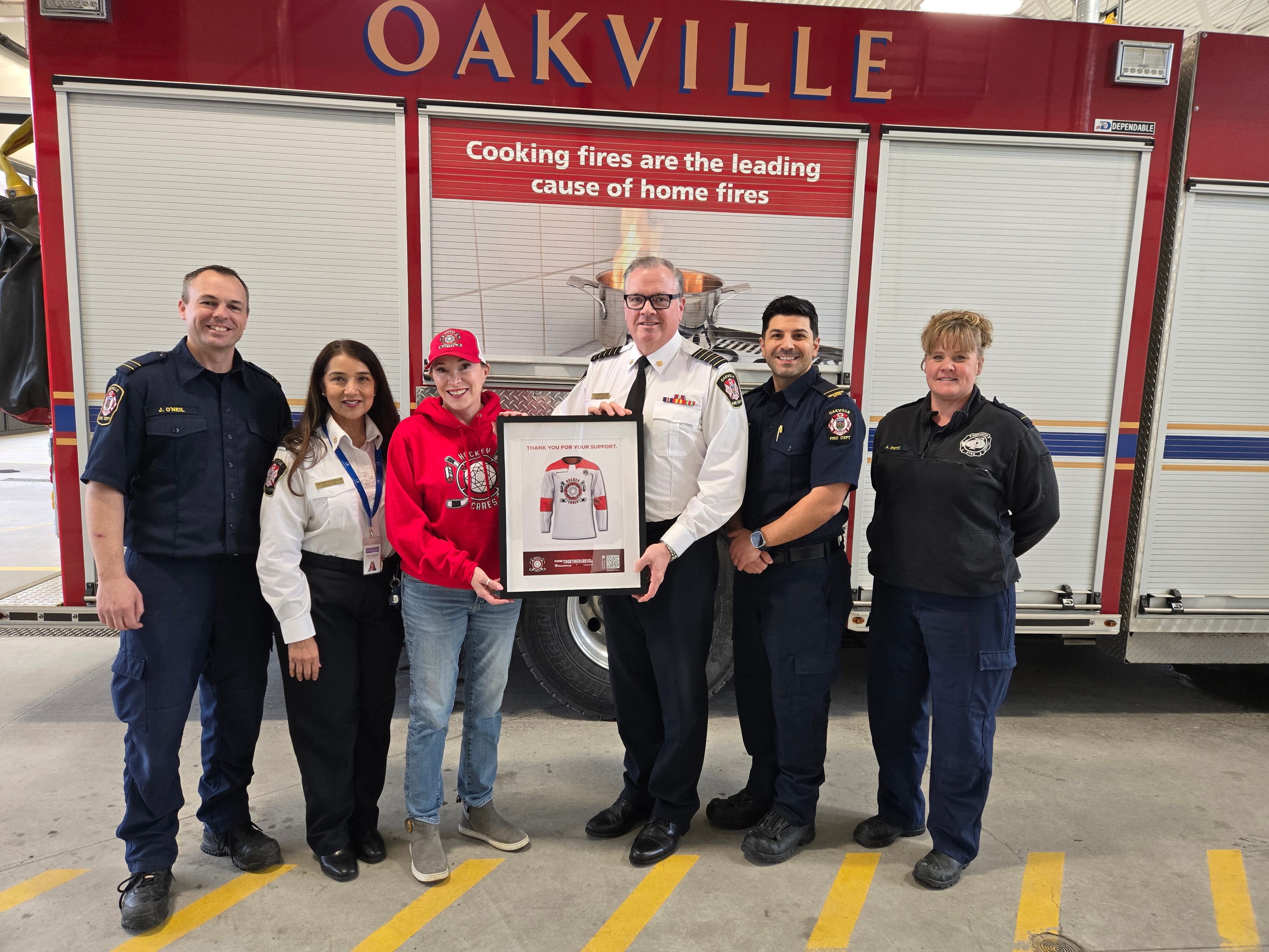Sue presenting a plaque to the Oakville fire department